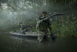 TWE300013M
Navy SEALs navigate the waters in a folding kayak during jungle warfare operations.