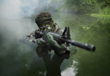 TWE300014M
Special operations forces soldier transits the water armed with an assault rifle.