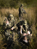 TWE300020M
U.S. Navy SEALs give first aid to a wounded soldier.