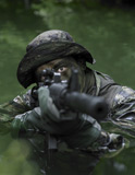 TWE300039M
Special operations forces soldier transits the water armed with an assault rifle.
