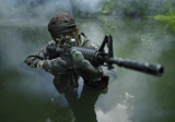 TWE300040M
Special operations forces soldier transits the water armed with an assault rifle.