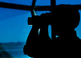 WOD100001M
A Navy air traffic controller maintains an alert watch with binoculars in the control tower.