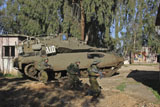 ZDN100148M
An Israel Defense Force Merkava Mark II battle tank with infantry forces.