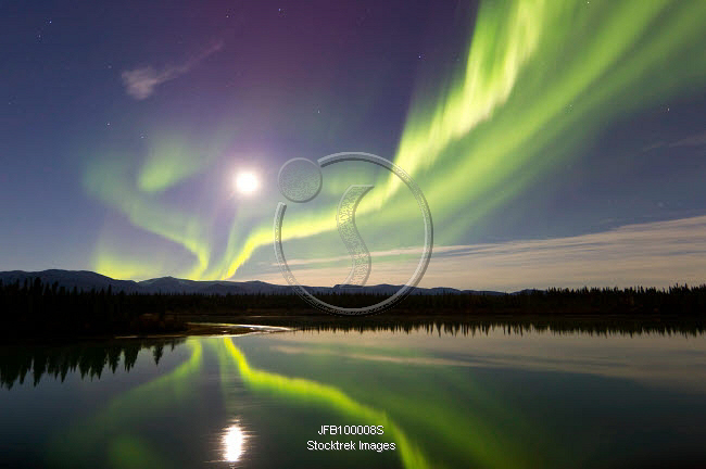 Aurora borealis and Full Moon over the Yukon River, Canada. | Stocktrek