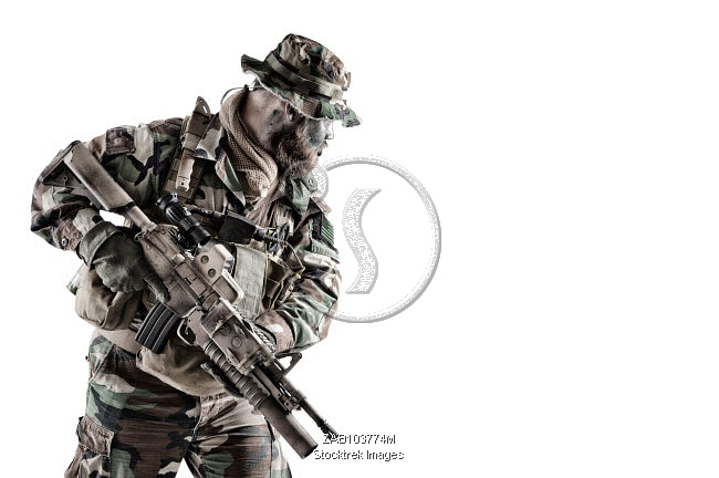 Commando soldier in camouflage uniform and boonie hat, armed with ...